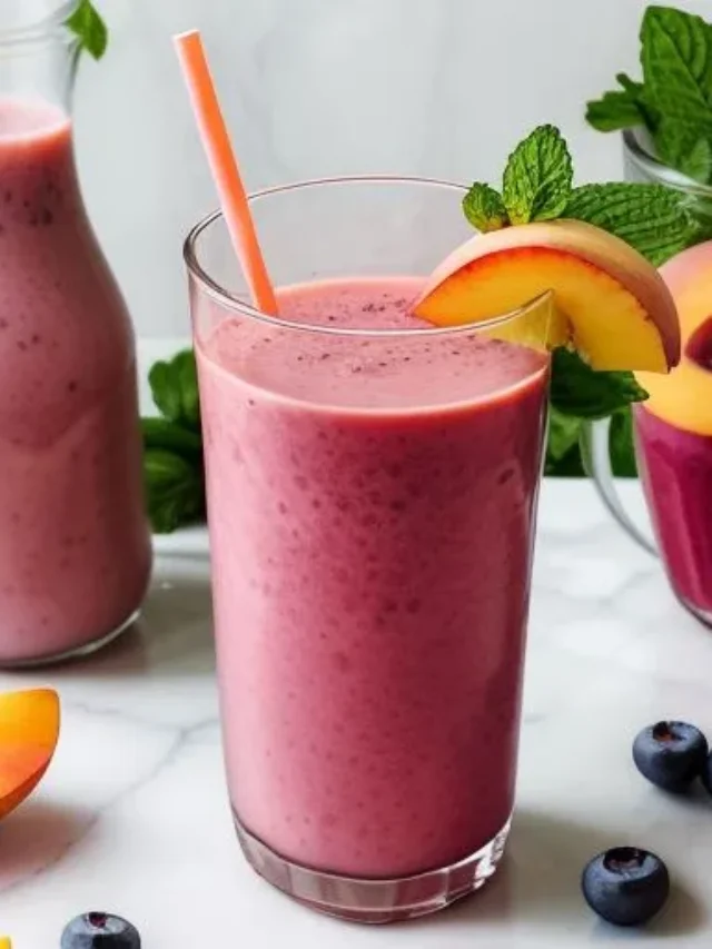 A refreshing green smoothie in a glass, garnished with fresh mint leaves and a slice of lime, radiating detoxifying and revitalizing energy. Berry Peach Sunrise Smoothie .