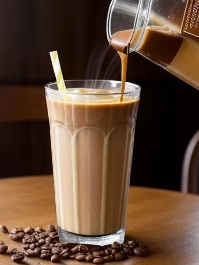 A creamy coffee smoothie in a glass, topped with a sprinkle of cocoa powder and coffee beans, exuding a rich and energizing appeal. Creamy Coffee Energizer Smoothie .