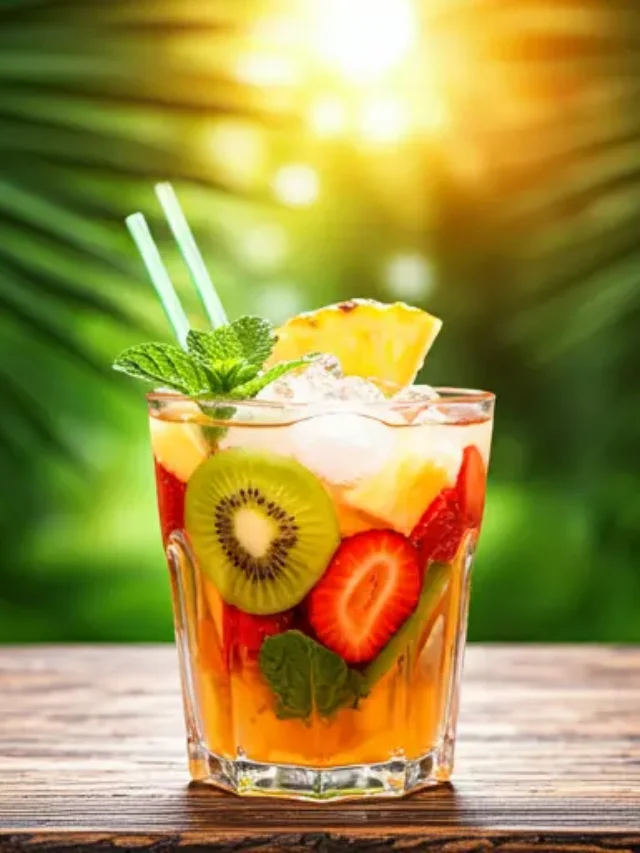 Exotic Bliss Punch : A tropical punch in a glass, featuring vibrant fruit slices and a colorful mix of tropical juices, exuding an exotic and refreshing vibe.