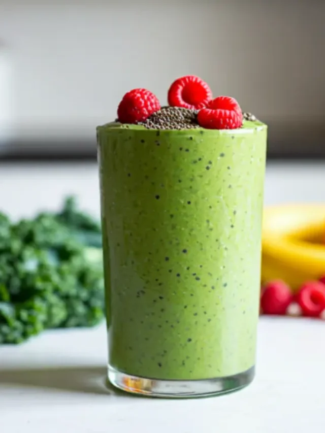 A vibrant green smoothie in a glass, garnished with fresh kale leaves and a mix of colorful berries, radiating health and energy. Kale Superfruit Power Smoothie .