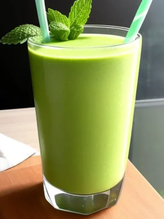 A refreshing green smoothie in a glass, garnished with fresh mint leaves and a slice of lime, radiating detoxifying and revitalizing energy. Refreshing Minty Green Detox Smoothie .