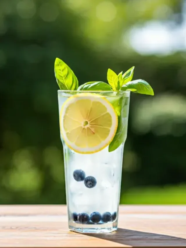 Summers Berry Basil Refresher : A vibrant red-pink juice in a glass, garnished with fresh berries and a sprig of basil, exuding a refreshing and summery vibe.