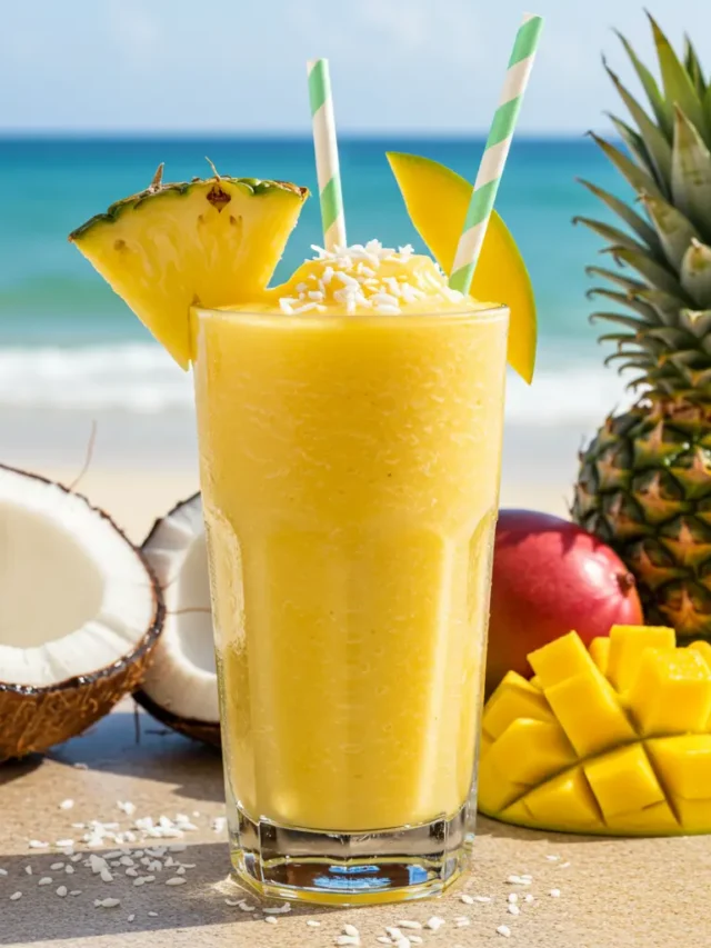 Fresh ingredients for Tropical Bliss Smoothie, including mango, pineapple, banana, and coconut milk, arranged on a rustic surface.