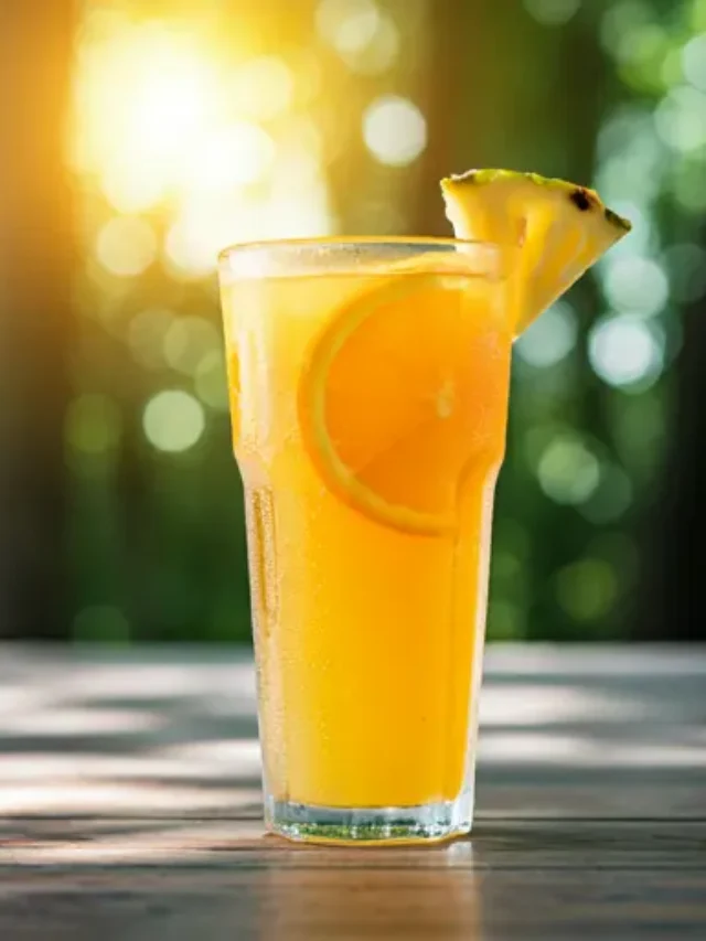 Citrus Glow Elixir : A golden-yellow citrus drink in a glass, garnished with a lemon wheel and a sprig of rosemary, glowing with refreshing vitality.