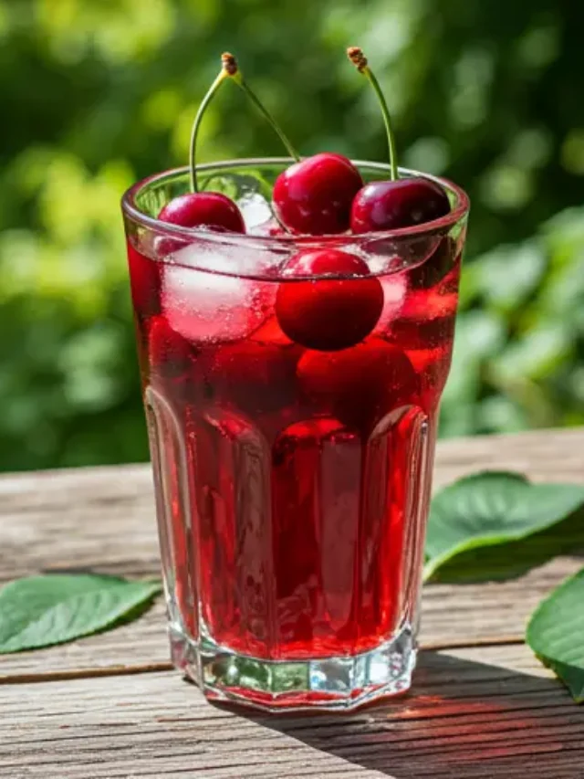 Crimson Cherry Elixir : A deep crimson-red elixir in a glass, topped with a fresh cherry and a mint sprig, exuding bold and vibrant energy.