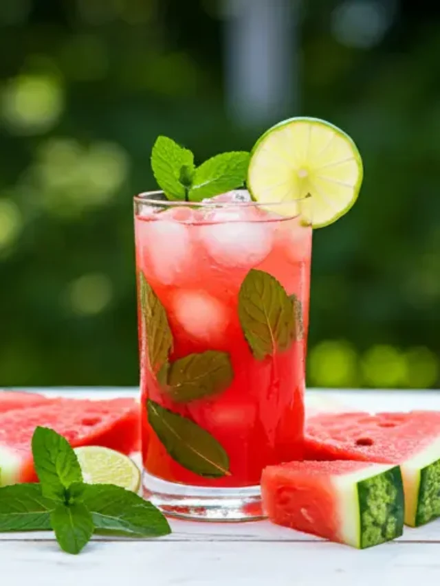 Refreshing Watermelon Delight The Ultimate Summer Sip A refreshing pink watermelon juice in a glass, topped with a watermelon wedge and a sprig of mint, exuding summer vibrancy.