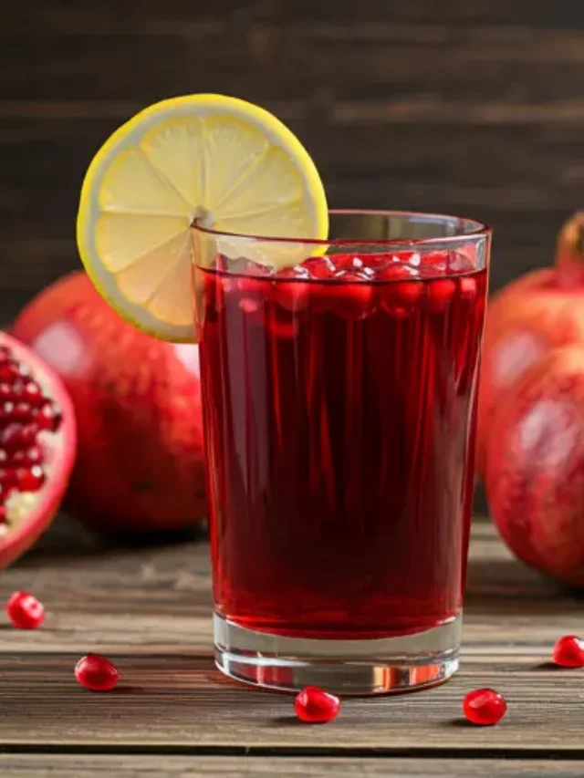 Ruby Nectar Delight : A vibrant ruby-red juice served in a glass, garnished with a slice of citrus and a sprig of mint, exuding a refreshing and fruity aroma.