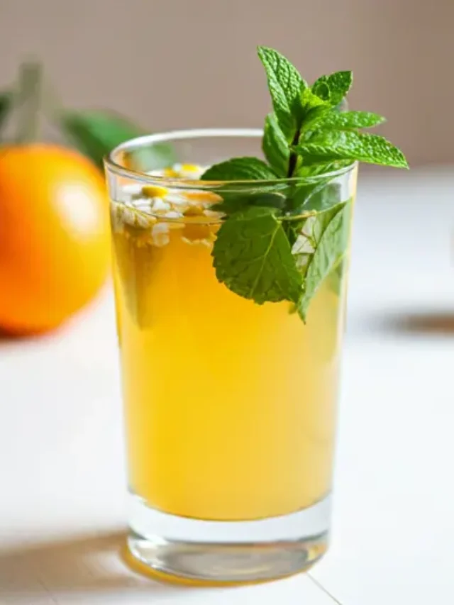 Soothing Citrus Breeze : A light orange drink in a glass, garnished with a slice of orange and a sprig of thyme, radiating calming citrus vibes.