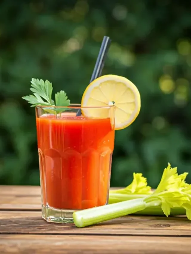 Spicy Tomato Elixir : A rich, red tomato elixir in a glass, garnished with a celery stalk and a sprinkle of chili flakes, exuding a bold and savory appeal.
