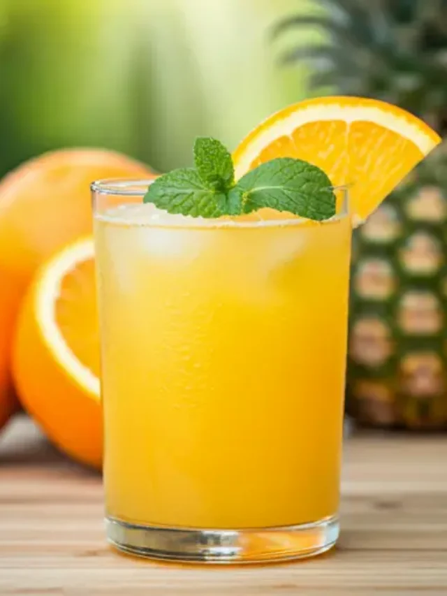 Sun-Kissed Citrus Delight : A bright orange citrus drink in a glass, topped with a slice of orange and a sprig of mint, radiating sunny and refreshing vibes.