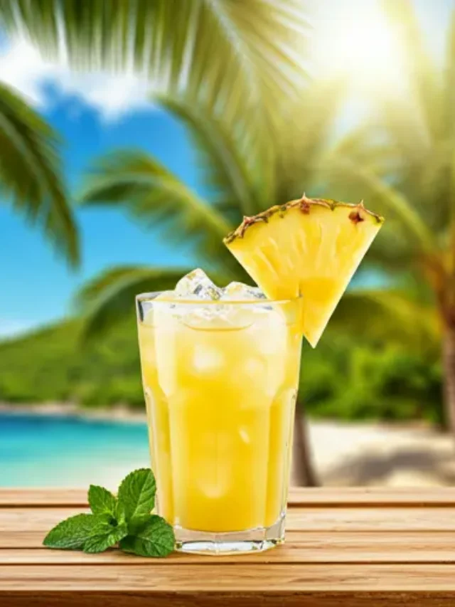 Tropical Pineapple Bliss : A creamy golden pineapple smoothie served in a chilled glass, topped with a pineapple wedge and a sprinkle of coconut flakes.