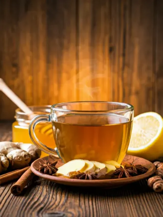 Vitality Elixir A Soothing Immunity Tea A warm golden tea in a mug, garnished with a lemon slice and a piece of fresh ginger, exuding soothing and healing energy.