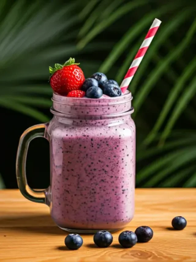 Berry Harmony Delight : A creamy berry smoothie in a glass, topped with fresh mixed berries.