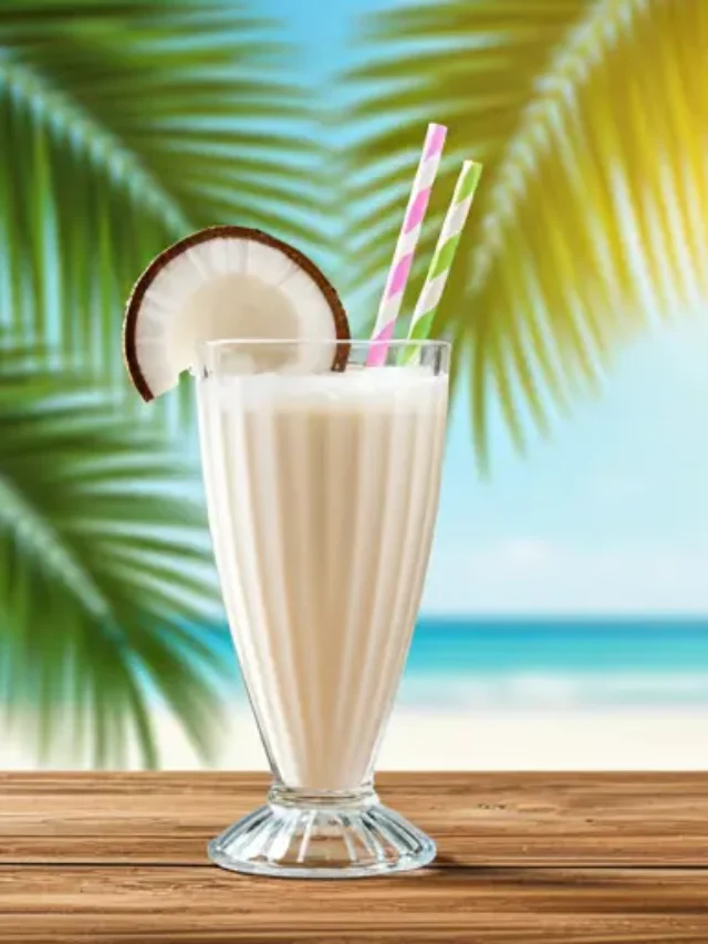 Coconut Cream Shake : A rich and creamy coconut shake in a tall glass, topped with whipped cream and toasted coconut flakes.