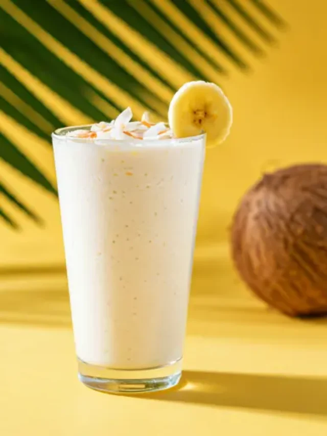 Creamy Coconut Bliss Smoothie : A luscious coconut smoothie in a tall glass, garnished with shredded coconut and a tropical touch.