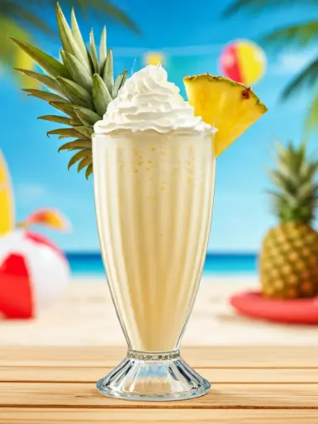 Pineapple Bliss Shake : A refreshing pineapple shake in a chilled glass, topped with a pineapple slice and a sprinkle of coconut flakes.