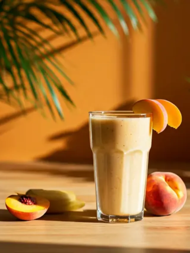 Sun-Kissed Banana Peach Smoothie : A creamy banana peach smoothie in a glass, topped with a peach slice and a sprinkle of chia seeds.
