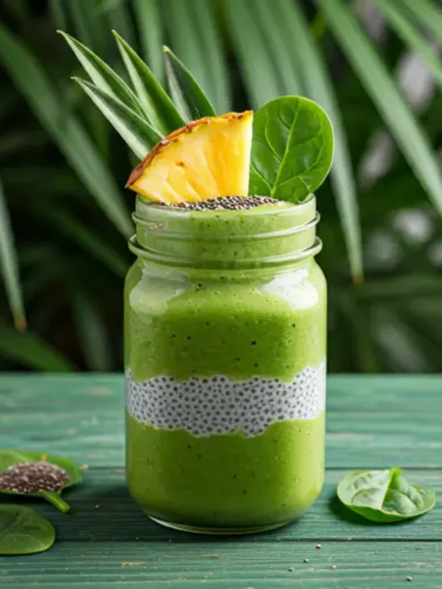 Tropical Green Pre-Workout Delight : A refreshing green smoothie in a glass, garnished with a slice of lime and fresh spinach leaves.
